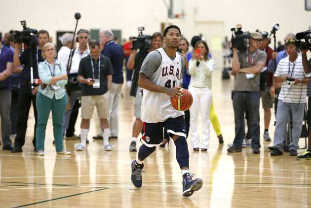 Reporters and photographers wait for Derrick Rose to finish his individual workout after a practice of the men's U.S. National basketball team in Chicago.